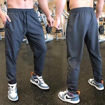 Erkekler Spor Pantolon Fermuar Cepler Eğitim Vücut Geliştirme Pantolon Spor Koşu Uzun Pantolon Ince Elastik Kuru Fit Sweatpants Dipleri